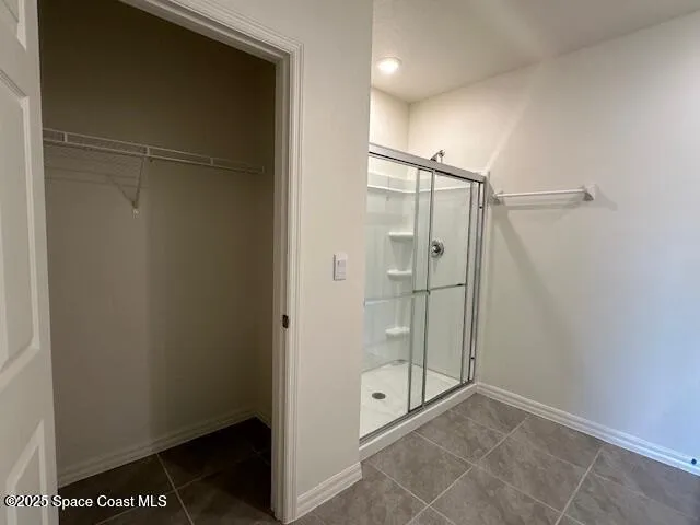 a bathroom with a glass shower door
