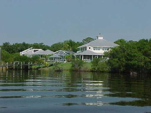 12184 Riverbend Road Port St. Lucie, FL 34984 - Photo 2 of 3 a view of a lake with a yard