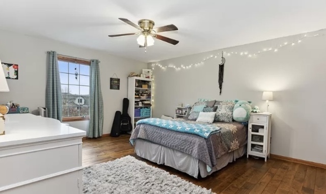 8708 South Rood Road Kingston, IL 60145 - Photo 11 of 15 a bedroom with a large bed and a chandelier