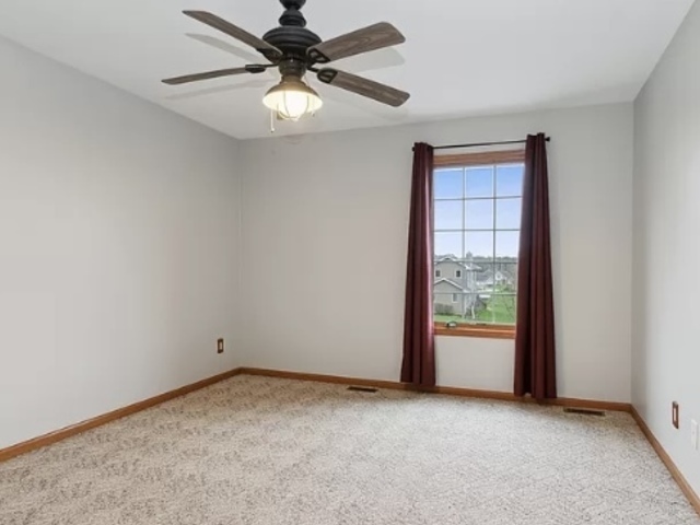 8708 South Rood Road Kingston, IL 60145 - Photo 12 of 15 an empty room with a window and a fan