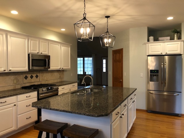 8708 South Rood Road Kingston, IL 60145 - Photo 4 of 15 a kitchen with kitchen island granite countertop a sink a counter space appliances and cabinets