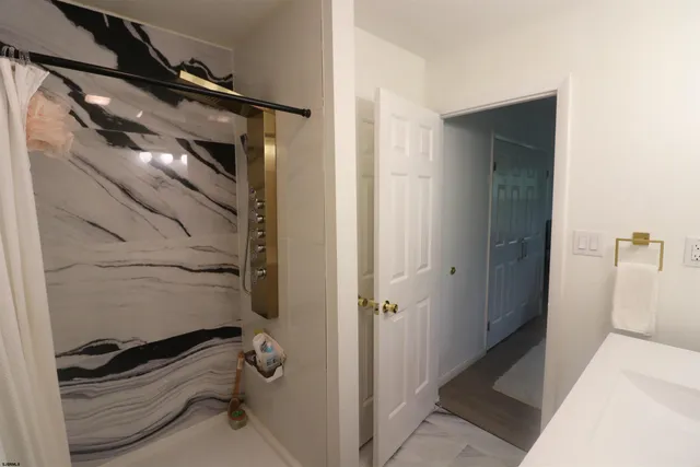 a bathroom with a shower and a sink