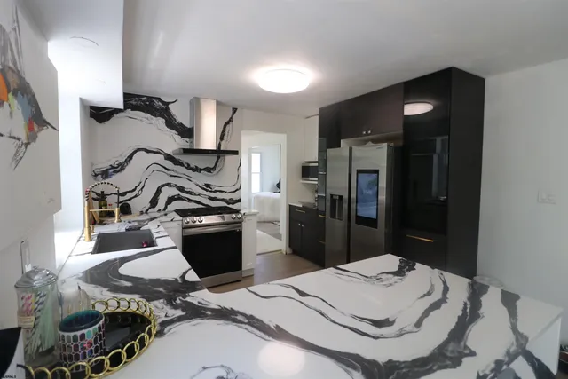 a kitchen with a refrigerator and a stove