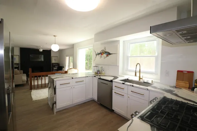 a kitchen with a sink stove and cabinets