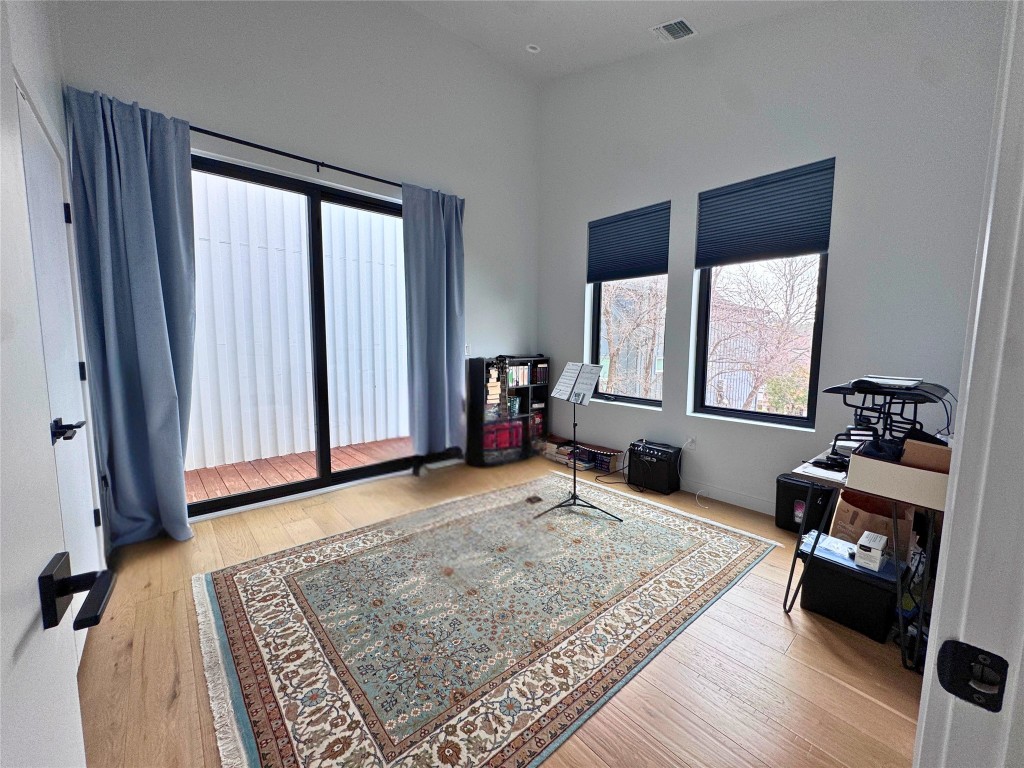 1206 Luna Street, Unit 2 Austin, TX 78721 - Photo 14 of 20 a bedroom with furniture and a window