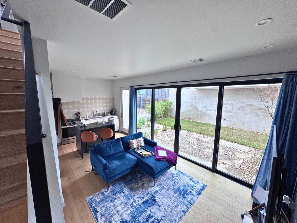 1206 Luna Street, Unit 2 Austin, TX 78721 - Photo 6 of 20 a living room with a couch and a floor to ceiling window