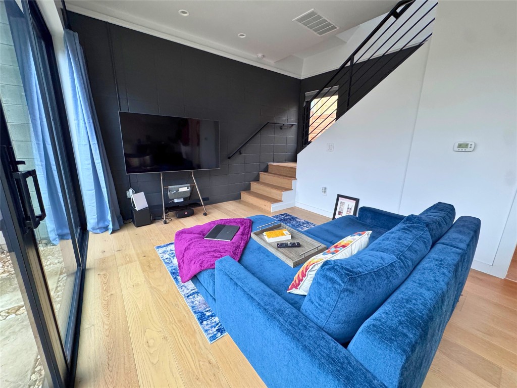 1206 Luna Street, Unit 2 Austin, TX 78721 - Photo 7 of 20 a living room with furniture and a flat screen tv