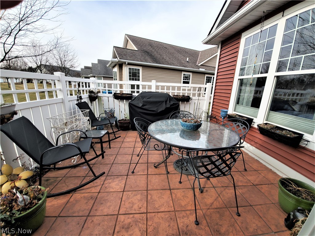 2347 Roxbury Road Avon, OH 44011 - Photo 21 of 35 Outdoor patio features a tiled floor and privacy fence, perfect for a BBQ get together!