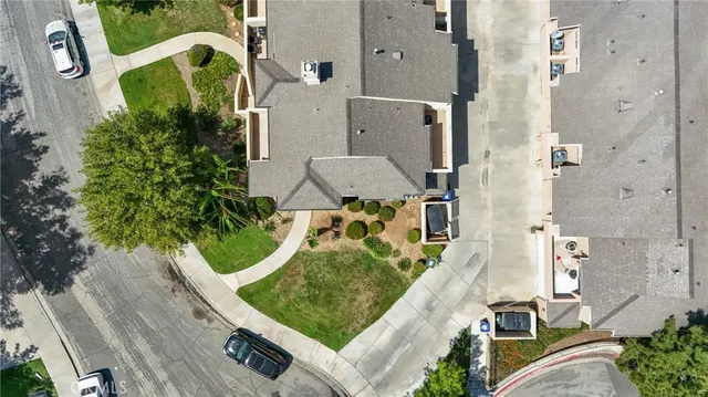 an aerial view of a house with a garden and trees