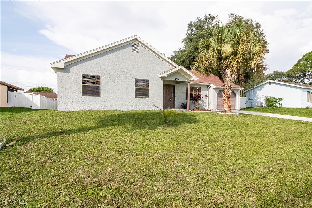 2802 31st Street Southwest Lehigh Acres, FL 33976 - Photo 2 of 16 a view of a house with a yard
