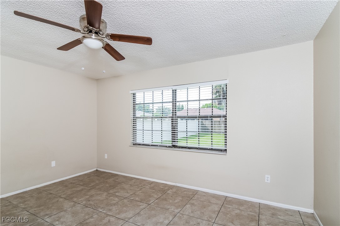 2802 31st Street Southwest Lehigh Acres, FL 33976 - Photo 8 of 16 a view of an empty room with a window
