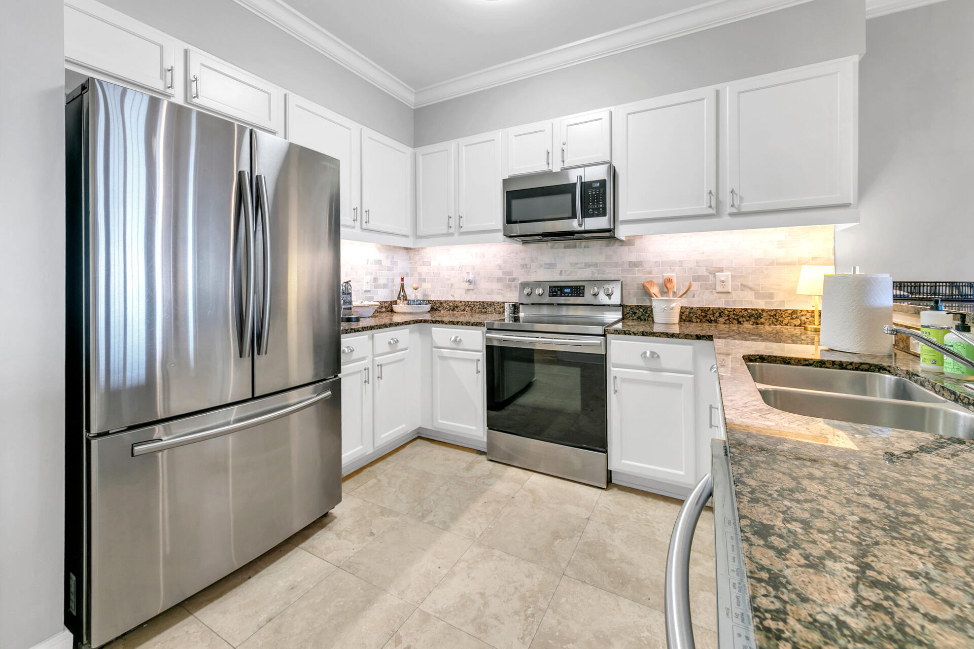 10343 East County Highway 30A, Unit 410 Inlet Beach, FL 32413 - Photo 11 of 32 a kitchen with stainless steel appliances granite countertop a refrigerator stove a sink and microwave