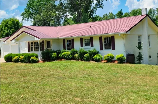 a view of a house with garden and yard