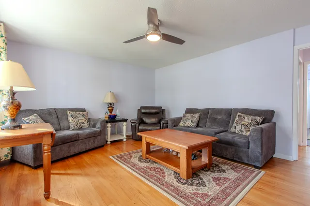 a view of a dining room with furniture and wooden floor