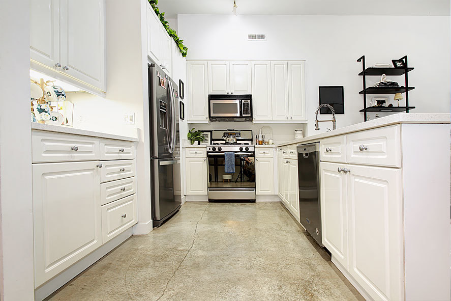 939 West Madison Street, Unit 510 Chicago, IL 60607 - Photo 7 of 13 a kitchen with white cabinets and stainless steel appliances