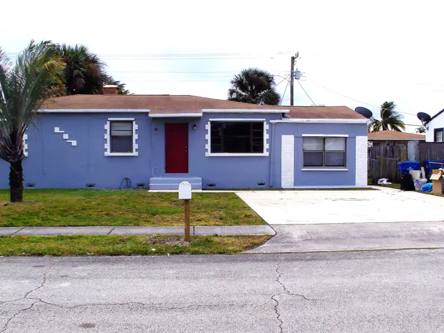 a brick house with a yard and table in front of it