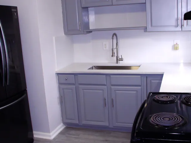 a stove top oven sitting inside of a kitchen