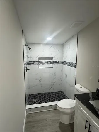 a bathroom with a toilet and a shower