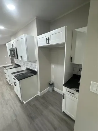 a kitchen with granite countertop a stove and a refrigerator