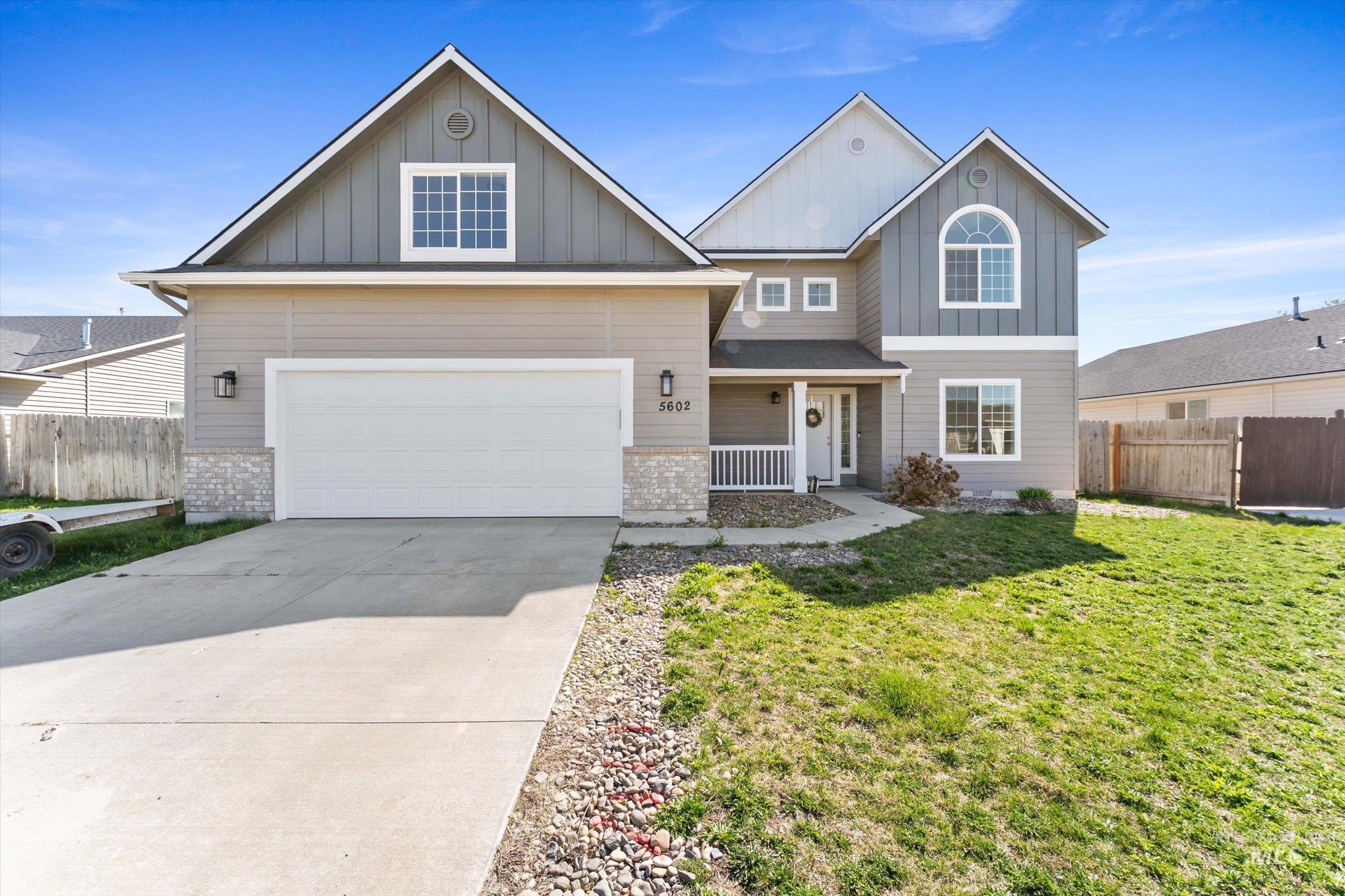 5602 Barkley Way Caldwell, ID 83607 - Photo 1 of 36 View of front of home with board and batten siding, driveway, covered porch, and a garage