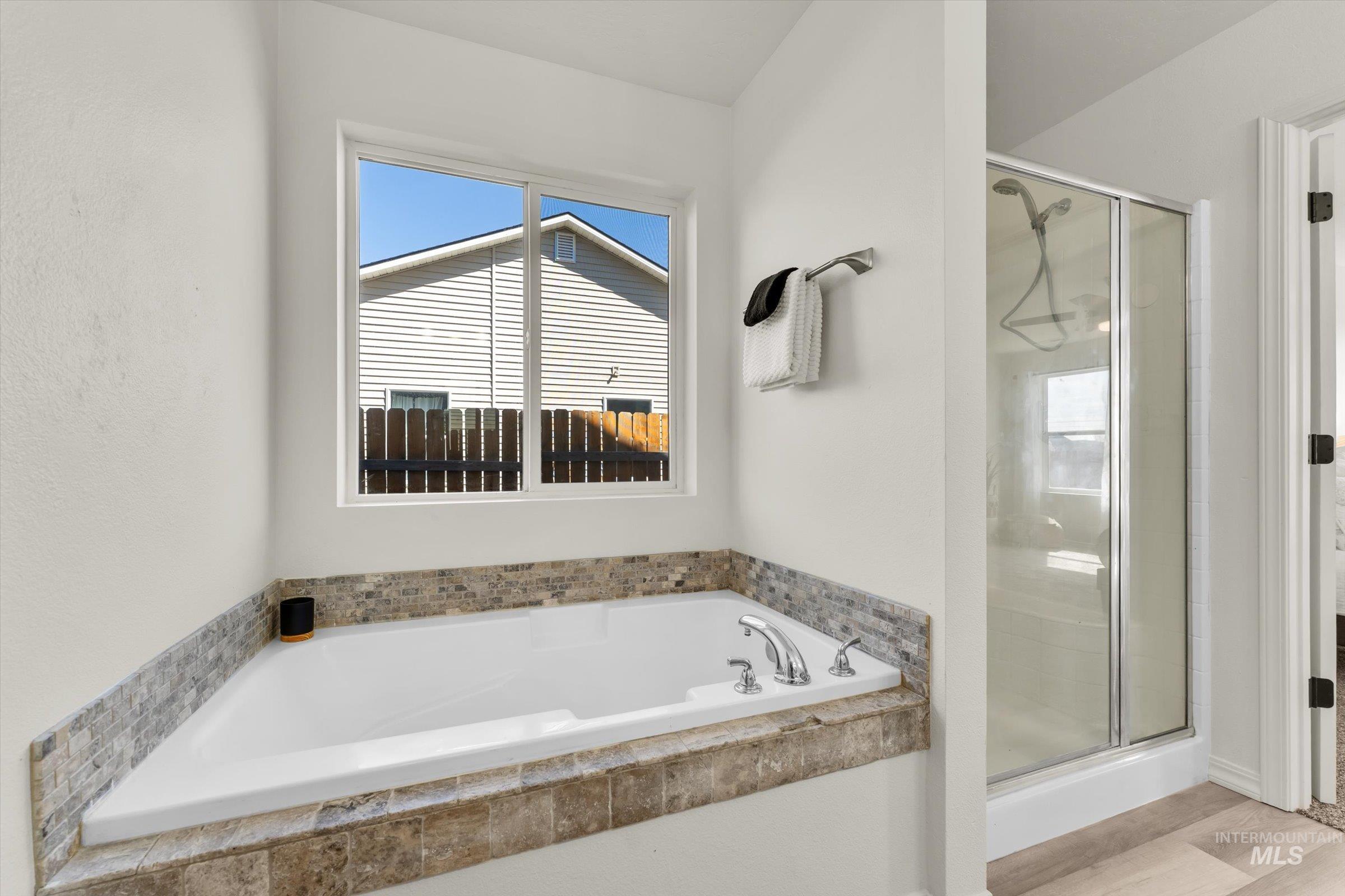 5602 Barkley Way Caldwell, ID 83607 - Photo 14 of 36 Bathroom featuring a bath and a stall shower