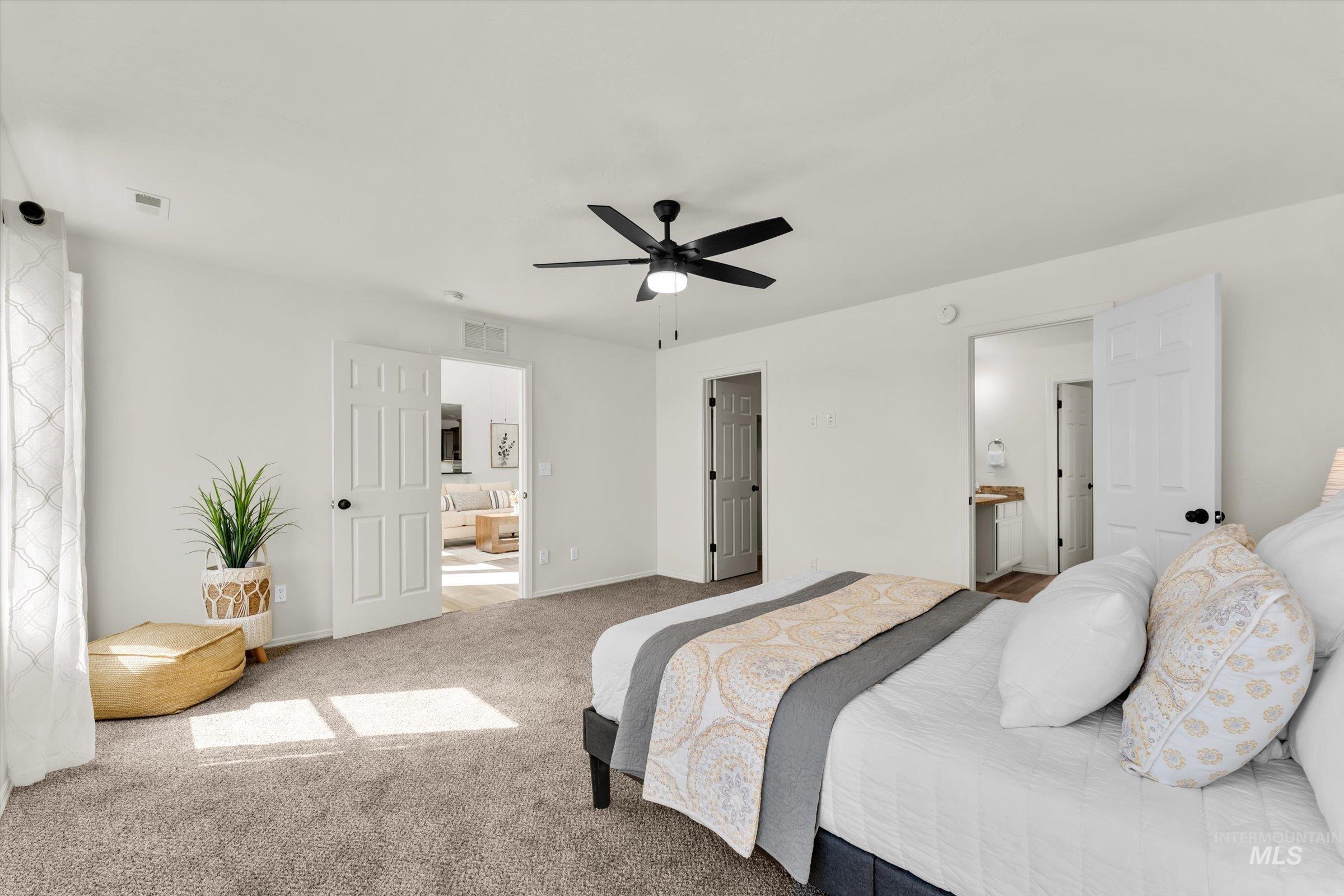 5602 Barkley Way Caldwell, ID 83607 - Photo 17 of 36 Bedroom with ensuite bath, carpet, and a ceiling fan