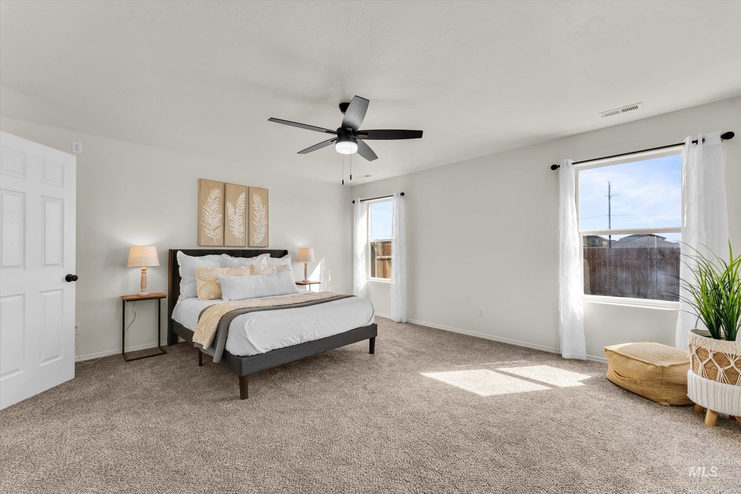 5602 Barkley Way Caldwell, ID 83607 - Photo 18 of 36 Bedroom with multiple windows, carpet flooring, and ceiling fan