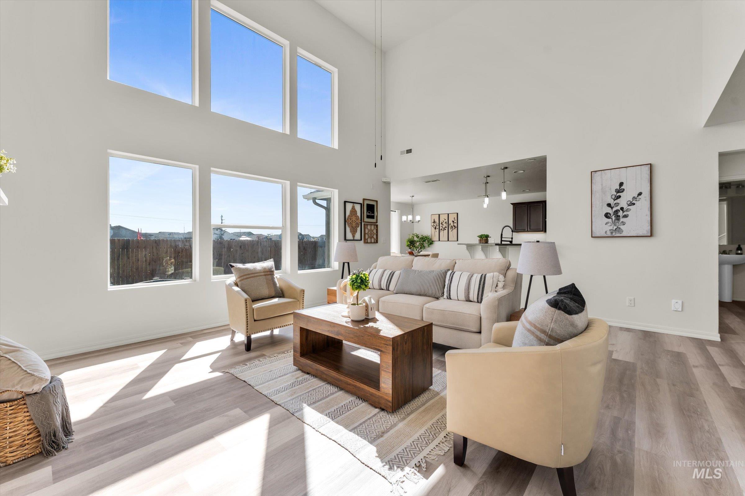 5602 Barkley Way Caldwell, ID 83607 - Photo 20 of 36 Living area with light wood-style flooring, a high ceiling, and a mountain view