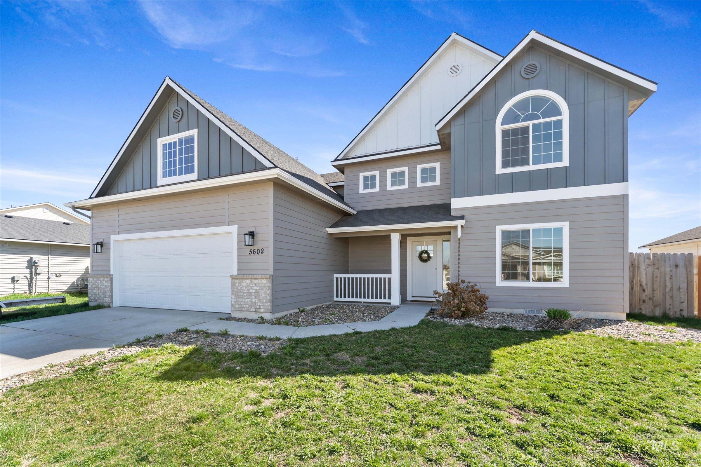 5602 Barkley Way Caldwell, ID 83607 - Photo 2 of 36 View of front of property with board and batten siding, concrete driveway, a shingled roof, and an attached garage