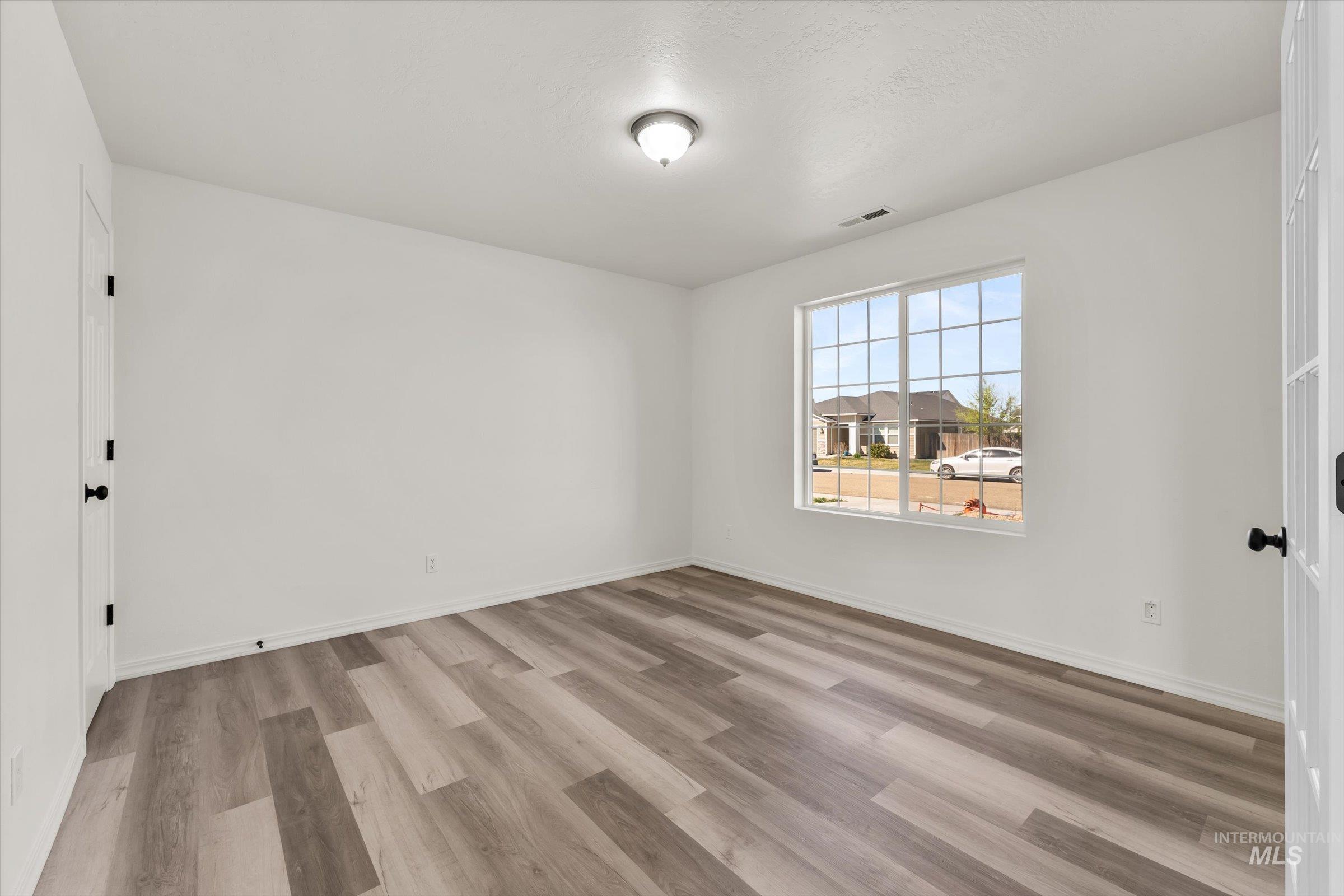5602 Barkley Way Caldwell, ID 83607 - Photo 23 of 36 Spare room with light wood-type flooring and baseboards