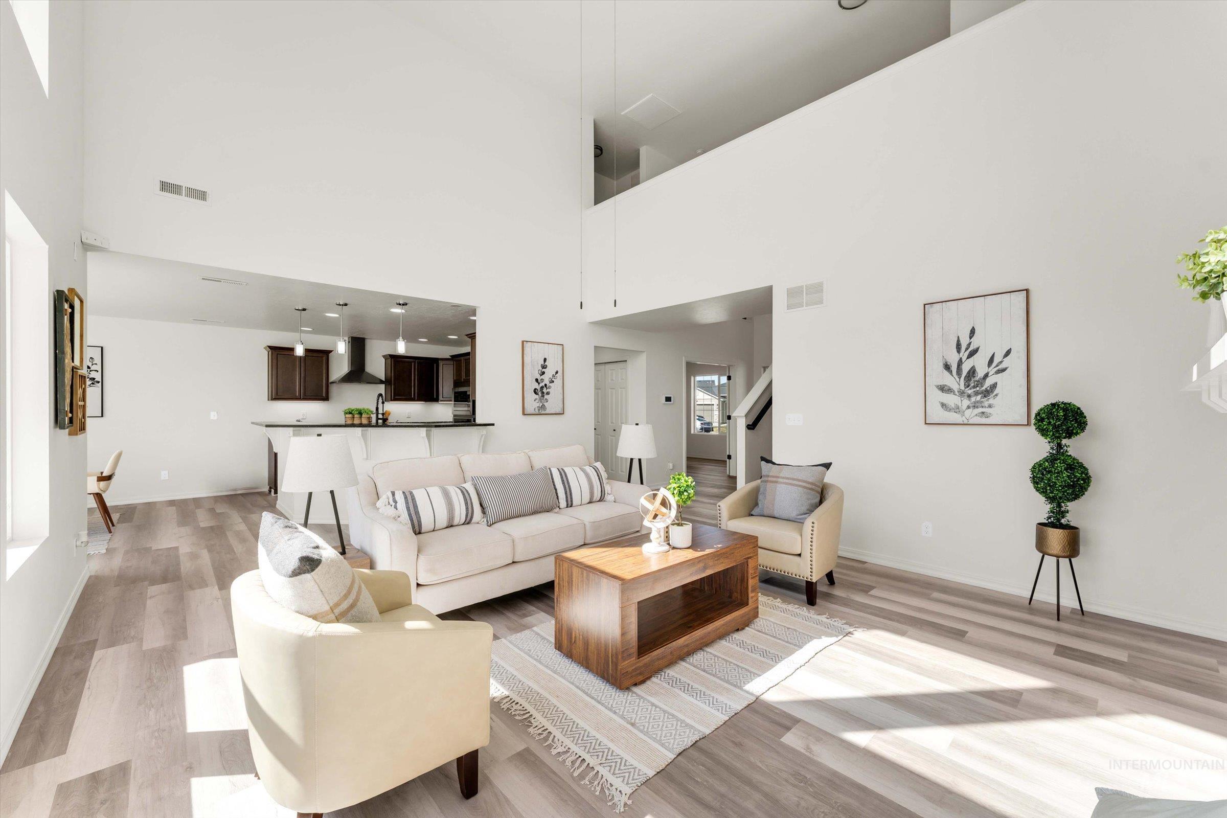 5602 Barkley Way Caldwell, ID 83607 - Photo 3 of 36 Living area with light wood finished floors and a high ceiling