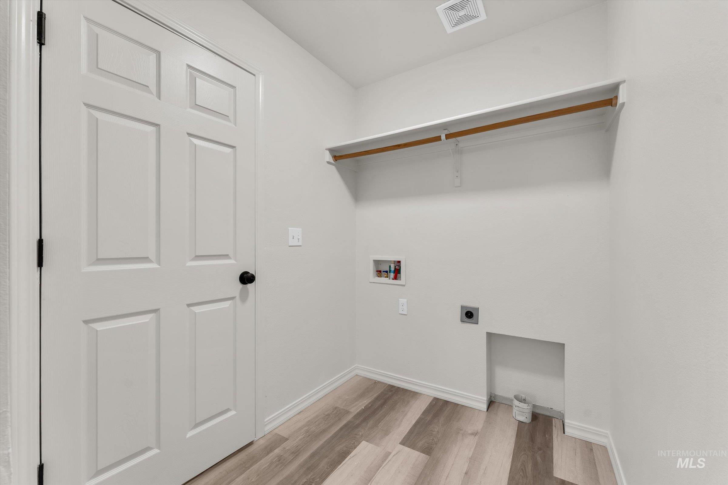 5602 Barkley Way Caldwell, ID 83607 - Photo 5 of 36 Laundry room featuring electric dryer hookup, light wood finished floors, and hookup for a washing machine