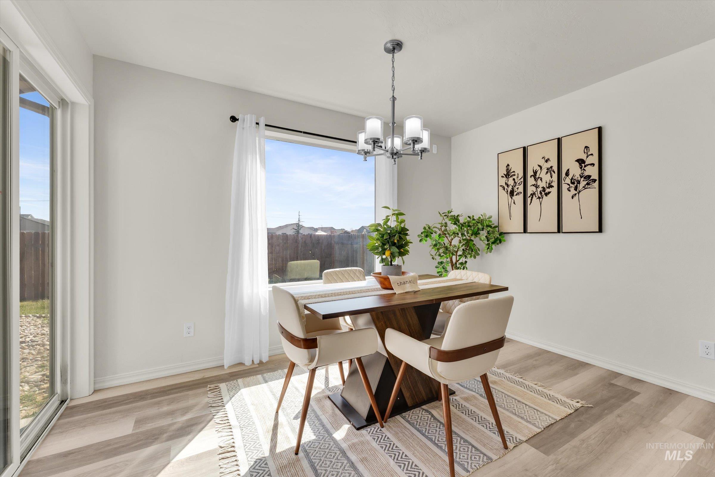 5602 Barkley Way Caldwell, ID 83607 - Photo 7 of 36 Dining space featuring hanging lights and light wood-style flooring
