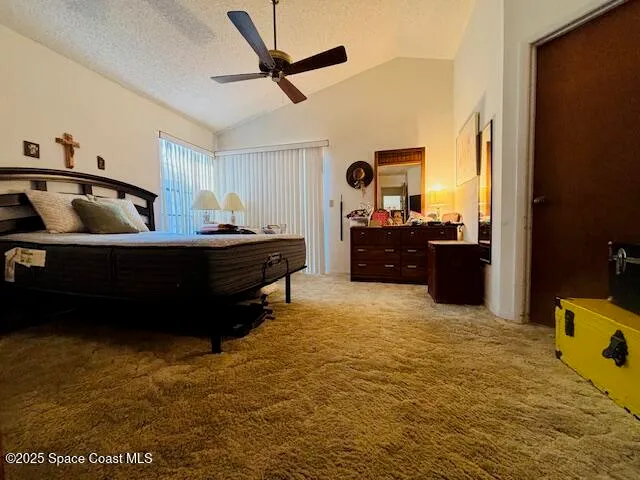 a living room with a bed furniture and a flat screen tv