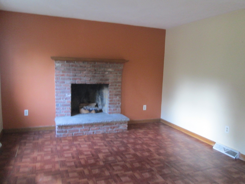 112 Clark Street, Unit 112 Belmont, MA 02478 - Photo 2 of 7 a view of empty room with a fireplace