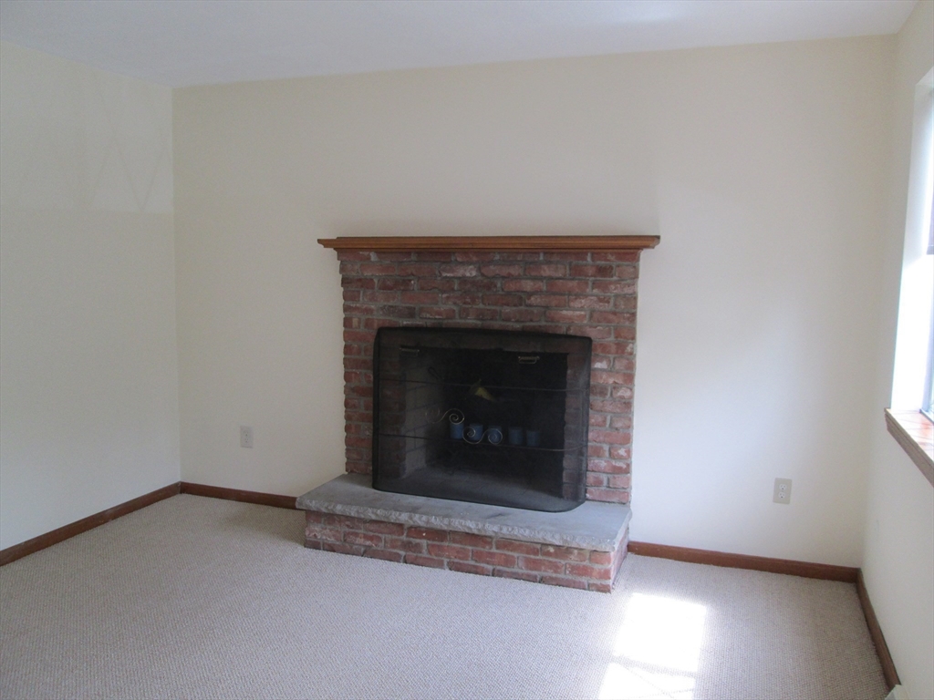 112 Clark Street, Unit 112 Belmont, MA 02478 - Photo 3 of 7 a room with a fireplace