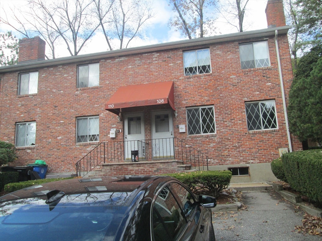 112 Clark Street, Unit 112 Belmont, MA 02478 - Photo 7 of 7 a front view of a house with garden