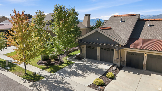 5207 North Oldgate Road Heber City, UT 84032 - Photo 49 of 58 Stone and siding exterior with multiple garage bays, a pergola accent, and a shingle roof