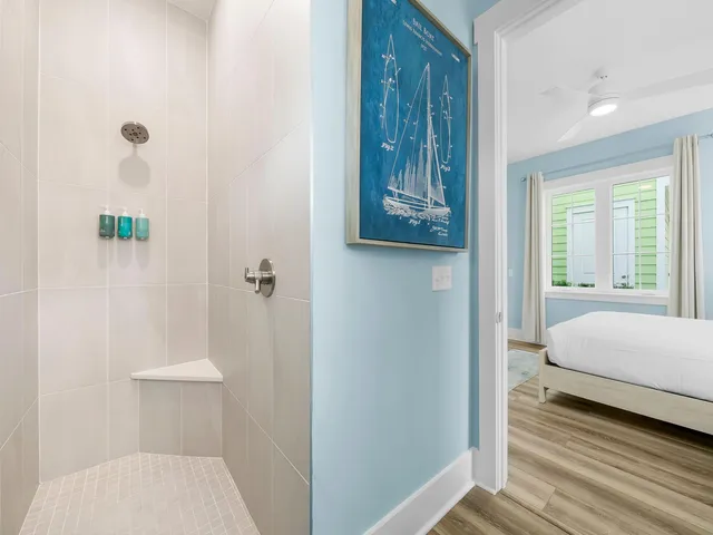 a bathroom with a toilet and a shower