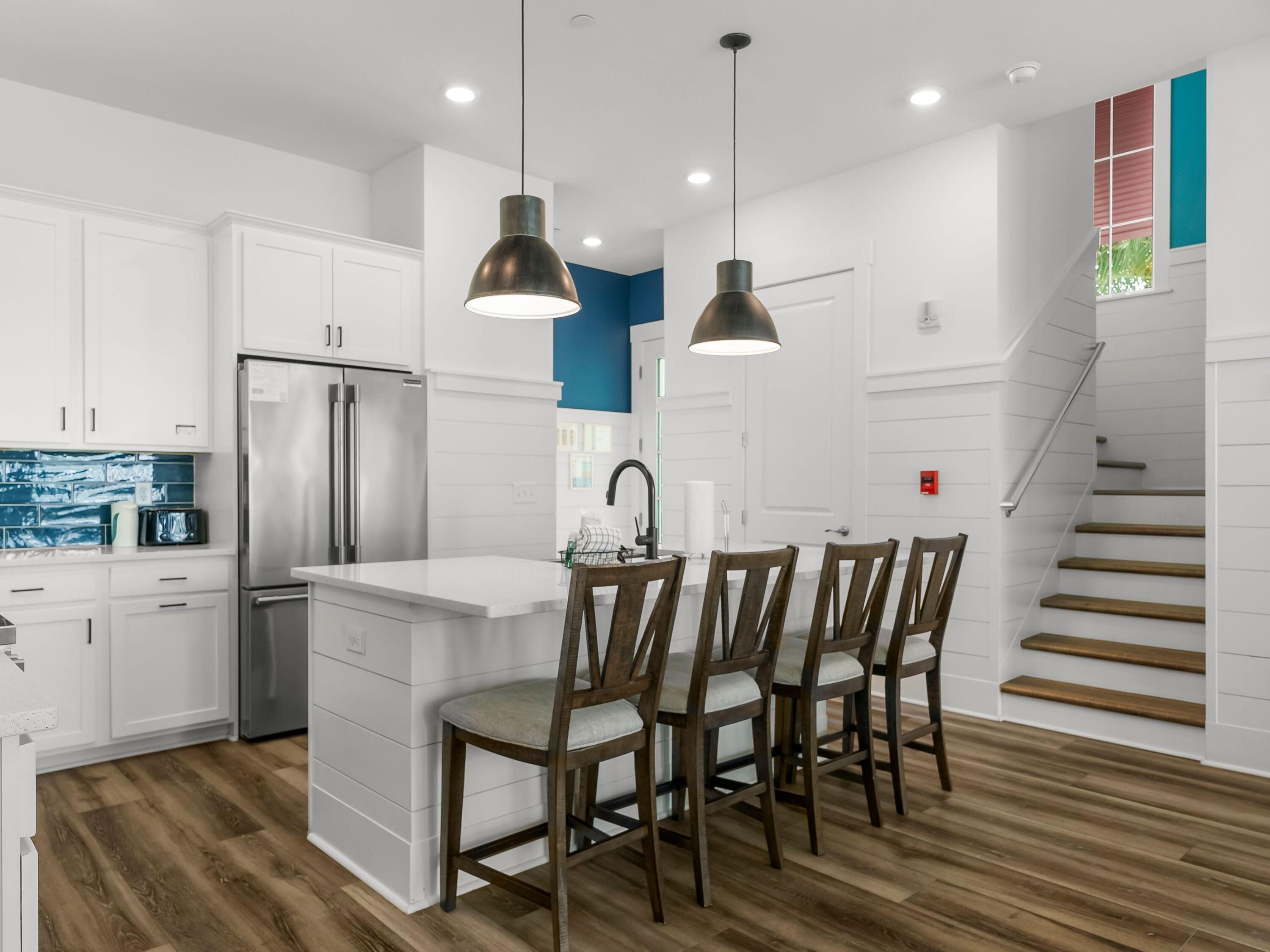 13650 Front Beach Road Panama City Beach, FL 32413 - Photo 23 of 49 a kitchen with granite countertop white cabinets and stainless steel appliances