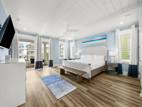 a spacious bedroom with a bed and a flat screen tv