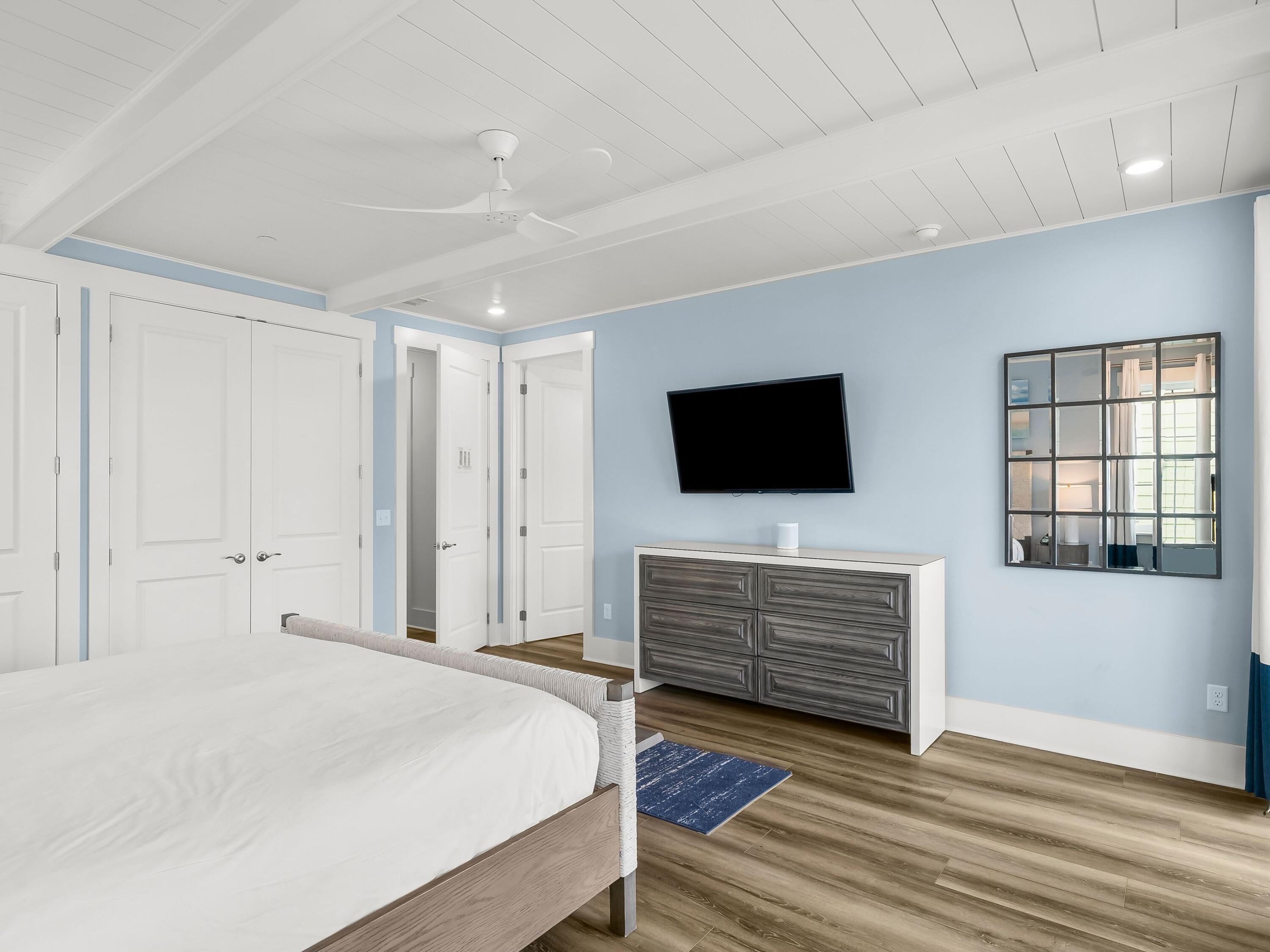 13650 Front Beach Road Panama City Beach, FL 32413 - Photo 26 of 49 a spacious bedroom with a bed and a flat screen tv