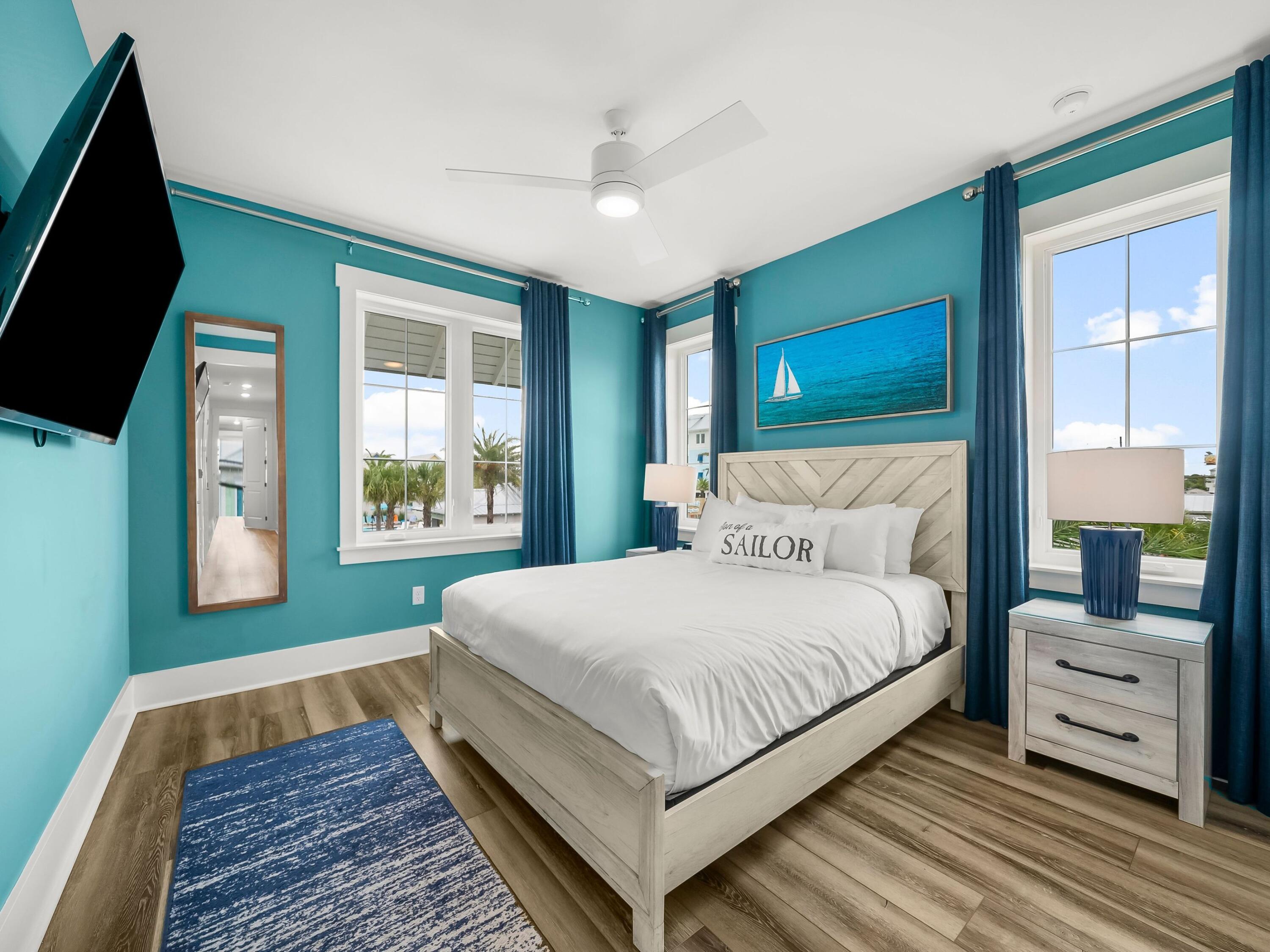 13650 Front Beach Road Panama City Beach, FL 32413 - Photo 34 of 49 a bedroom with bed and a flat tv screen on dresser