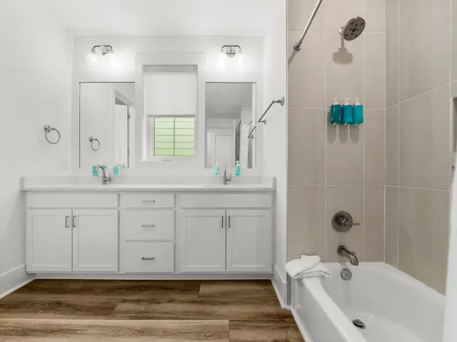 a spacious bathroom with double sink and a mirror