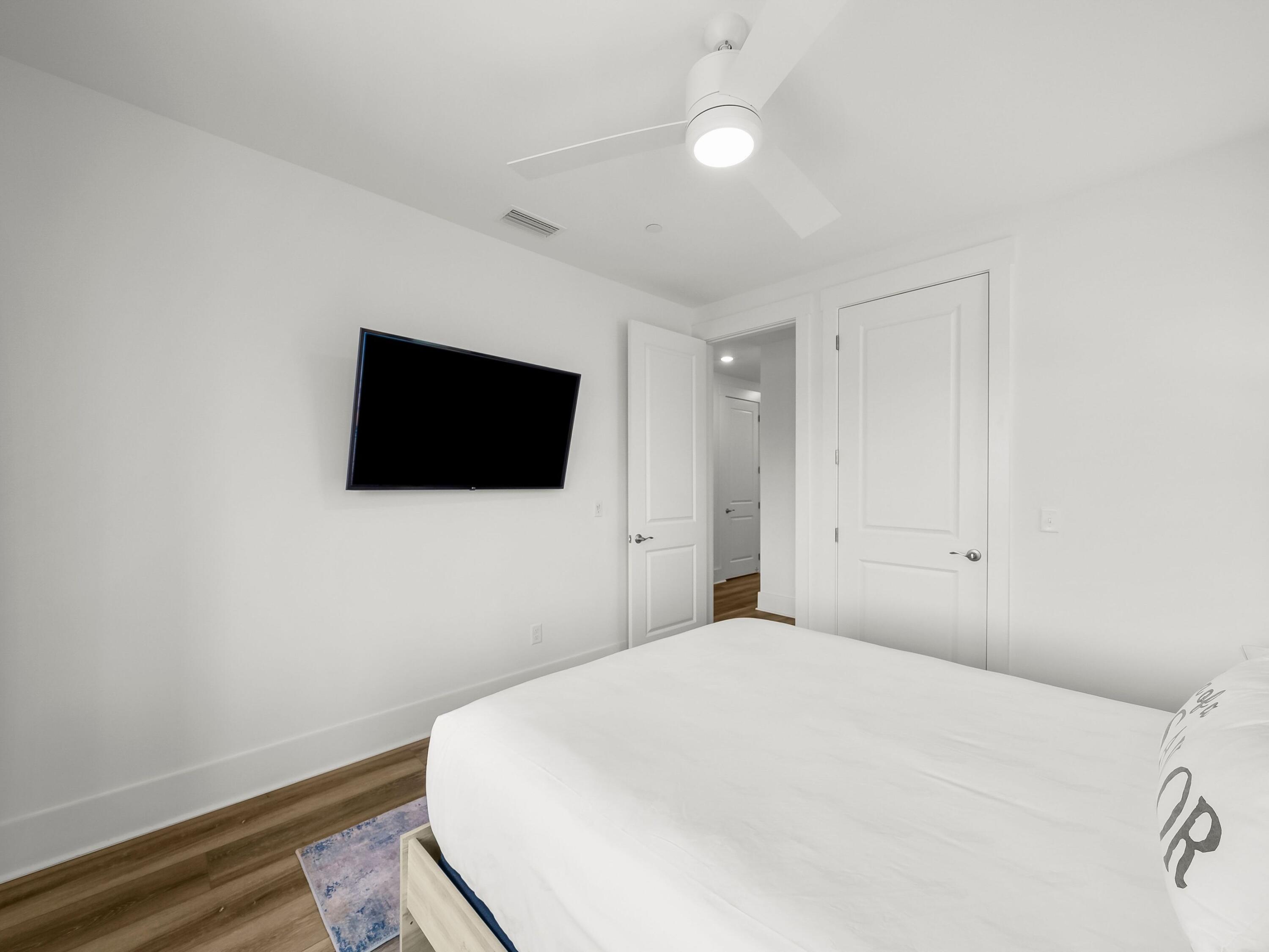 13650 Front Beach Road Panama City Beach, FL 32413 - Photo 39 of 49 a bedroom with a bed and a flat screen tv