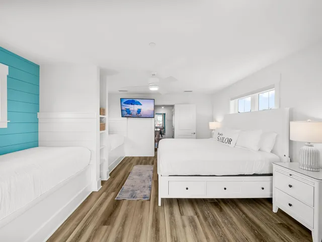 a bedroom with a large bed and a chandelier