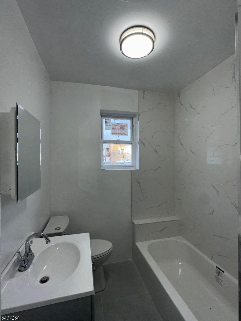 336 Broad Street, Unit 2 Bloomfield, NJ 07003 - Photo 21 of 24 a bathroom with a sink mirror toilet and bathtub