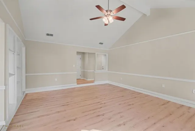 wooden floor in an empty room with a window