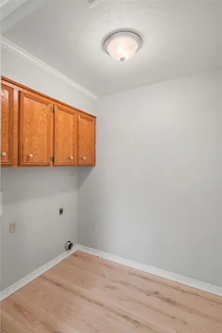 a view of a room with wooden floor and fan