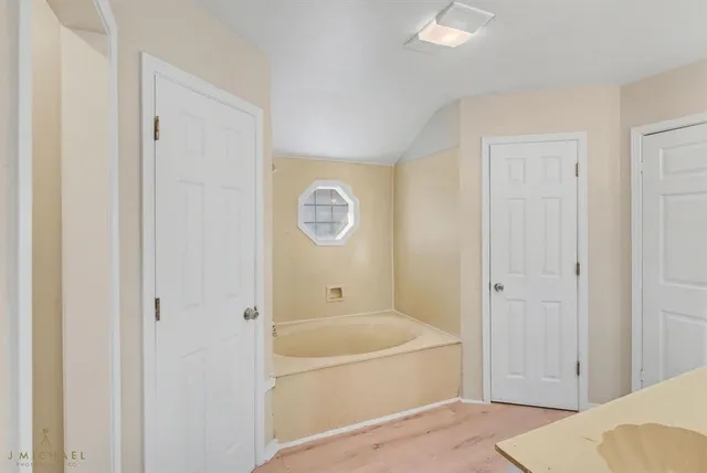 a bathroom with a tub and shower